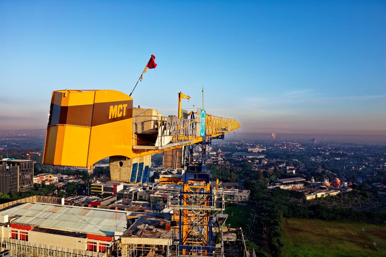 Aerial view of a construction crane overlooking Serpong cityscape during the day.